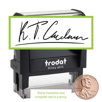 Black Trodat signature stamp with a penny for size comparison on a white background